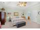 Comfortable main bedroom with tray ceiling, neutral carpet, and ensuite bath access at 2636 Brick Dr., Longs, SC 29568