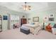 Spacious main bedroom with tray ceilings, ceiling fan and large windows at 2636 Brick Dr., Longs, SC 29568