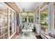 Relaxing sunroom with brick accents, comfortable seating, and natural light streaming through the windows at 2636 Brick Dr., Longs, SC 29568