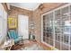 Inviting sunroom with brick walls, comfortable seating, and views of the outdoors at 2636 Brick Dr., Longs, SC 29568
