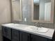 Bathroom with dual sinks, marble countertops, grey shaker cabinets, and tiled backsplash at 2705 Capricorn Dr., Myrtle Beach, SC 29575