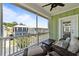 Relaxing balcony with comfortable wicker furniture and a pleasant neighborhood view on a sunny day at 281 Lumbee Circle, Pawleys Island, SC 29585