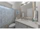 Bathroom with granite countertop, stylish fixtures, and decorative shower curtain at 281 Lumbee Circle, Pawleys Island, SC 29585