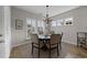 Charming dining room featuring a round table, seating for six, and natural light from shuttered windows at 281 Lumbee Circle, Pawleys Island, SC 29585