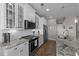 Well-appointed kitchen featuring granite countertops, stainless steel appliances, and modern white cabinetry at 281 Lumbee Circle, Pawleys Island, SC 29585
