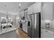 Bright kitchen with stainless steel appliances, white cabinetry, and a view of the dining area at 281 Lumbee Circle, Pawleys Island, SC 29585