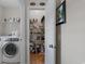 Well-organized laundry area with washer, shelving, and a pantry stocked with various items at 281 Lumbee Circle, Pawleys Island, SC 29585