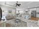 Open-concept living room featuring hardwood floors, neutral tones, and seamless access to the kitchen and dining area at 281 Lumbee Circle, Pawleys Island, SC 29585