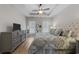 Serene main bedroom with tray ceiling, hardwood floors, and a comfortable upholstered bed at 281 Lumbee Circle, Pawleys Island, SC 29585
