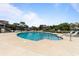 Community outdoor pool area with plenty of seating, surrounded by lush greenery and residential buildings at 281 Lumbee Circle, Pawleys Island, SC 29585