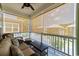 Enclosed porch with sun shades, comfortable seating, and scenic neighborhood views at 281 Lumbee Circle, Pawleys Island, SC 29585