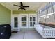 Relaxing porch with a swing bed, ceiling fan, and outdoor grill at 281 Lumbee Circle, Pawleys Island, SC 29585