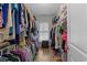 Organized walk-in closet with rods and shelves filled with an array of clothing and shoes at 281 Lumbee Circle, Pawleys Island, SC 29585