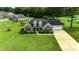 A lovely brick home with a pristine lawn and long driveway in a well-maintained neighborhood at 301 Farmtrac Dr., Aynor, SC 29544