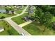 Aerial view showing a brick home with a large yard, nestled in a neighborhood with ponds and trees at 301 Farmtrac Dr., Aynor, SC 29544