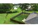 Aerial view of a large, fenced backyard with a brick home and a glimpse of a nearby pond at 301 Farmtrac Dr., Aynor, SC 29544