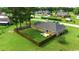 A brick home with a fenced backyard, featuring a well-maintained lawn and a small patio area at 301 Farmtrac Dr., Aynor, SC 29544