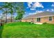 Backyard featuring grass, trees and brick exterior of home at 301 Farmtrac Dr., Aynor, SC 29544