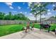 Backyard featuring patio with chairs and grill, grass and trees at 301 Farmtrac Dr., Aynor, SC 29544