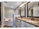 Bathroom featuring double vanity with granite countertop and soaking tub at 301 Farmtrac Dr., Aynor, SC 29544