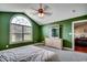 Bedroom features a large arched window, door and green walls at 301 Farmtrac Dr., Aynor, SC 29544