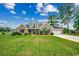 Inviting two-story brick home with dormer windows, an attached garage, and lush green lawn at 301 Farmtrac Dr., Aynor, SC 29544