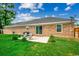 Brick exterior with a patio and well-maintained lawn at 301 Farmtrac Dr., Aynor, SC 29544