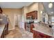 Kitchen with stainless appliances, tile floors, granite countertops, and wood cabinets at 301 Farmtrac Dr., Aynor, SC 29544