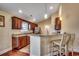 Modern kitchen with breakfast bar, hardwood floors, granite countertops and stainless steel refrigerator at 301 Farmtrac Dr., Aynor, SC 29544
