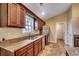 The kitchen features wood cabinets, stone countertops, and stainless steel appliances at 301 Farmtrac Dr., Aynor, SC 29544