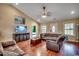 Bright living room with vaulted ceilings, hardwood floors, and comfortable seating at 301 Farmtrac Dr., Aynor, SC 29544