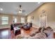 Cozy living room featuring hardwood floors, vaulted ceilings, and a comfortable couch at 301 Farmtrac Dr., Aynor, SC 29544