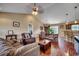 Spacious living room with hardwood floors and vaulted ceilings that opens to the kitchen and dining area at 301 Farmtrac Dr., Aynor, SC 29544