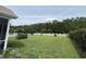 Large backyard with a white picket fence, garden plots, and mature trees at 348 Basswood Ct., Conway, SC 29526