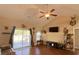 Bright and open living room featuring hardwood floors and sliding glass door to patio at 348 Basswood Ct., Conway, SC 29526