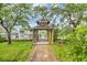 Charming wooden gazebo on a lush lawn offers serene waterfront views and access to a private dock at 3659 Jordan Landing Rd., Murrells Inlet, SC 29576