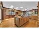 Spacious kitchen featuring an island with a cooktop and sink, along with hardwood floors and wood paneled walls at 3659 Jordan Landing Rd., Murrells Inlet, SC 29576