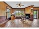 Cozy living room with wood paneled walls, hardwood floors, and large windows with natural light at 3659 Jordan Landing Rd., Murrells Inlet, SC 29576