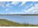 Expansive waterfront view of waterway homes against a blue sky, showcasing coastal living at its finest at 3659 Jordan Landing Rd., Murrells Inlet, SC 29576