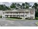 Two story condo building with white railings, stairs, and lush landscaping at 3677 Clay Pond Village Ln. # 6, Myrtle Beach, SC 29579