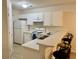 A bright kitchen with white cabinets, appliances, and a breakfast bar at 3677 Clay Pond Village Ln. # 6, Myrtle Beach, SC 29579
