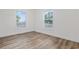 Bright bedroom featuring wood-look flooring and two large windows at 3759 Green Sea Rd., Green Sea, SC 29545