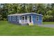 Charming home featuring blue siding, a welcoming front porch, and a well-maintained lawn at 3759 Green Sea Rd., Green Sea, SC 29545