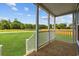 The porch has white railings, wooden floors, and offers a view to an ample green yard at 3759 Green Sea Rd., Green Sea, SC 29545