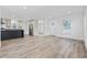 Spacious living room with wood-look floors, white walls, and views into the modern kitchen at 3759 Green Sea Rd., Green Sea, SC 29545
