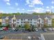 Attractive condo building featuring brick accents, multiple balconies, and ample parking spaces at 3762 Citation Way # 1023, Myrtle Beach, SC 29577
