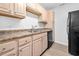 Bright kitchen with light wood cabinets, laminate countertops, and black appliances at 3762 Citation Way # 1023, Myrtle Beach, SC 29577