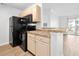 Compact kitchen featuring black appliances, light wood cabinetry, and laminate countertops at 3762 Citation Way # 1023, Myrtle Beach, SC 29577