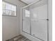Bright bathroom featuring a modern shower with glass doors, window, and neutral wall and floor tones at 3768 Green Sea Rd., Green Sea, SC 29545