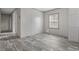 Neutral toned bedroom with an egress window, built-in storage, and grey wood-look flooring at 3768 Green Sea Rd., Green Sea, SC 29545